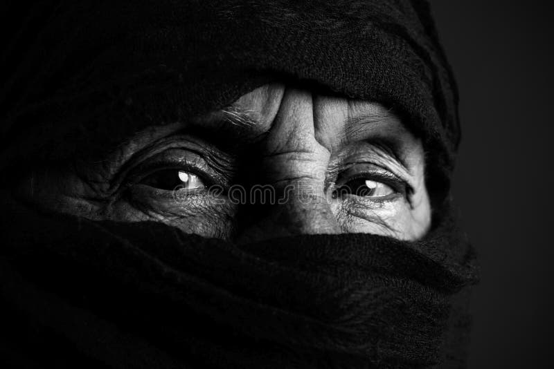 Eyes of senior muslim woman with niqab, looking at camera, black and white. Eyes of senior muslim woman with niqab, looking at camera, black and white