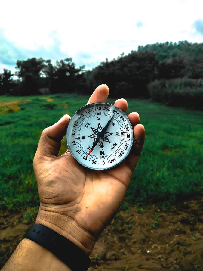HOLDING COMPASS in HAND stock photo. Image of 166473776