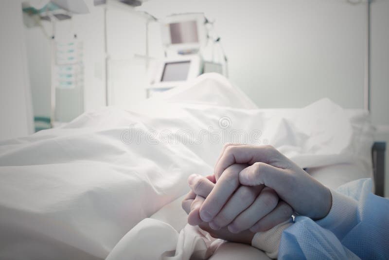 Holding the hand of a dying man