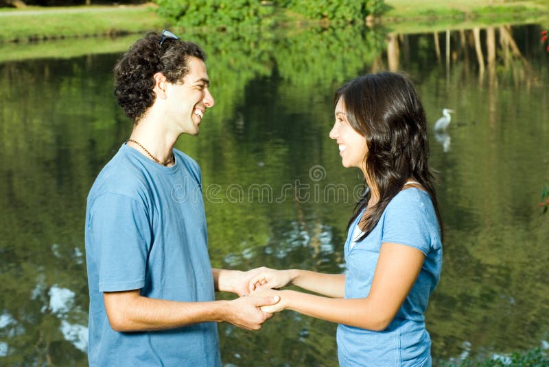 Holding Hands by a Pond. - Horizontal