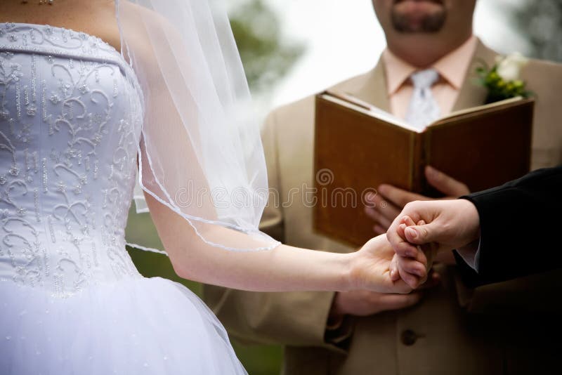 Holding hands during a wedding ceremony