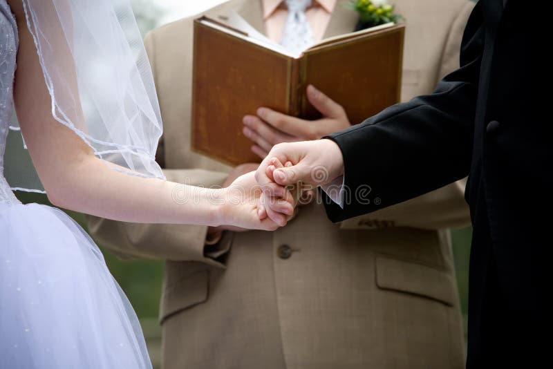Holding hands during a wedding ceremony