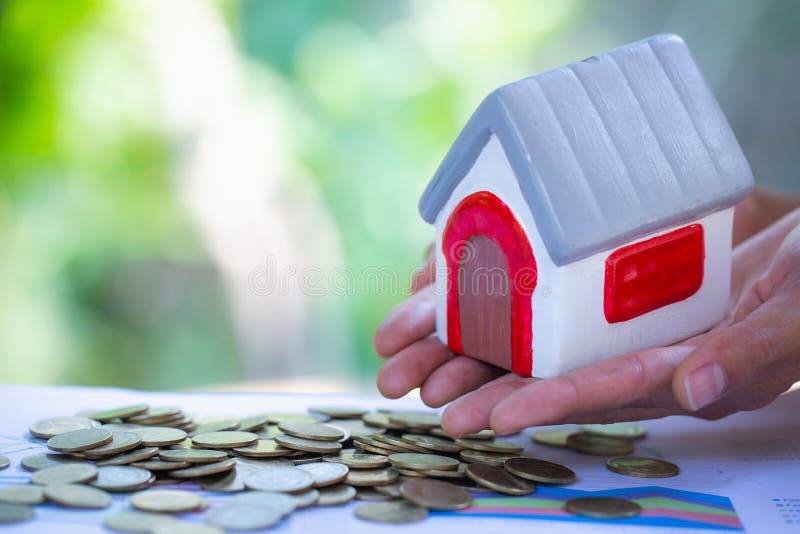 Holding house representing home ownership, mortgage, investment, real estate and property concept stock image Holding house representing home ownership, mortgage, investment, real estate and property concept stock image