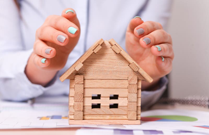 Holding house representing home ownership and the Real Estate business royalty free stock photo Holding house representing home ownership and the Real Estate business royalty free stock photo