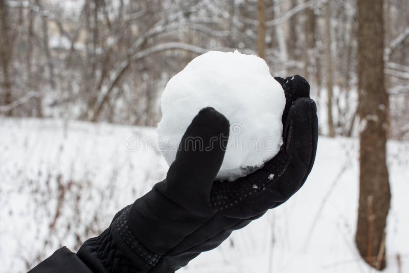 Holding a snowball with black gloves