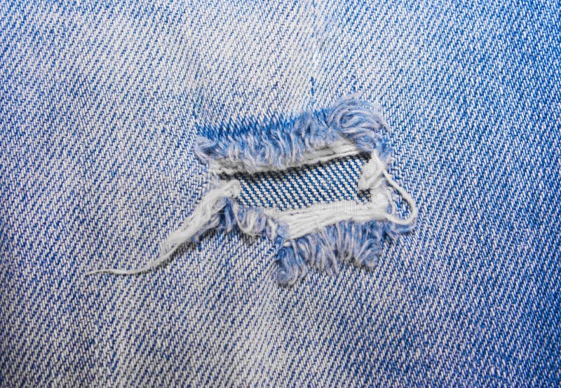 The hole on the blue jeans stock image. Image of female - 86716393