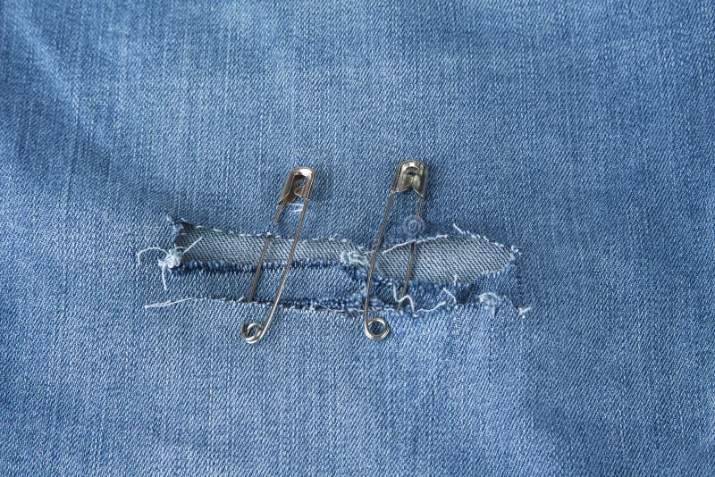 Hole in Blue Jeans Fixed with Safety Pins Stock Image Image of pins