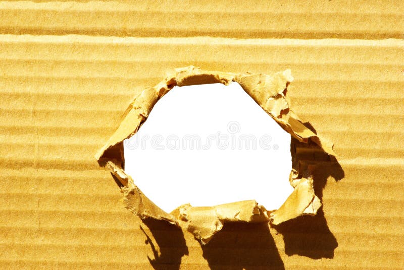 Hole in cardboard stock image. Image of power, material 6171027