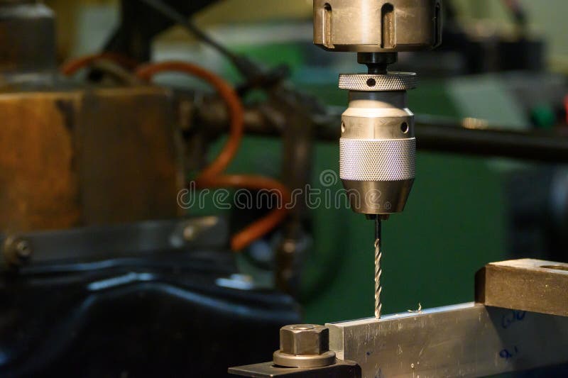 The hole drilling process on NC milling machine with drill tools stock images
