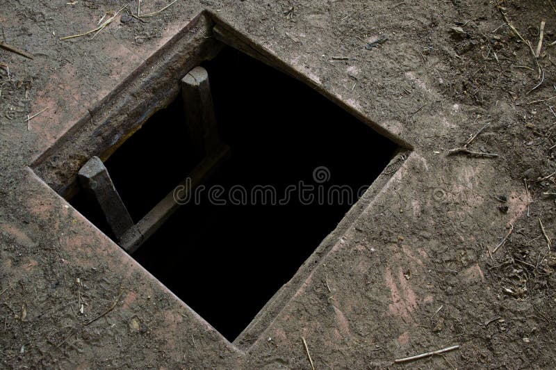 Hole in floor of old house leading to cellar