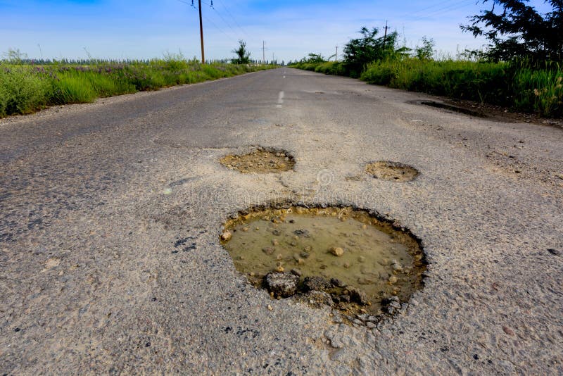 Holes on asphalt road royalty free stock image
