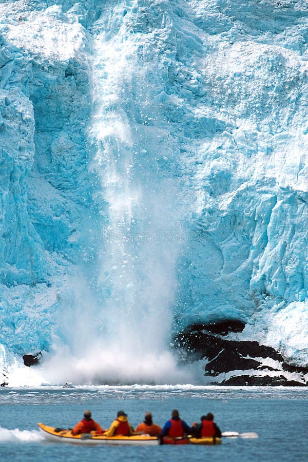 Holgate Glacier calving as kayakers watch in Alaska at Kenai royalty free stock images Holgate Glacier calving as kayakers watch in Alaska at Kenai royalty free stock images