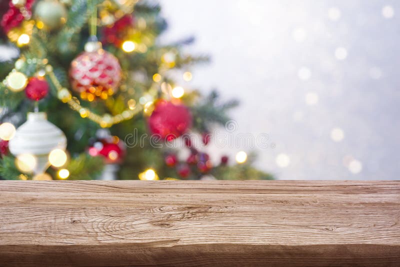Christmas Tree Defocused Background with Wooden Table in Front Stock