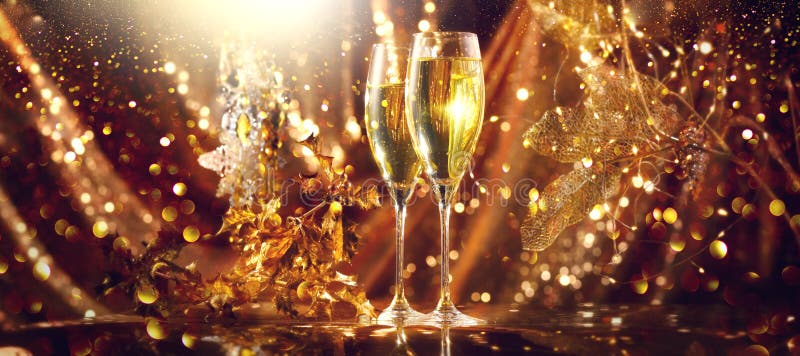 Holiday Champagne Flute over Golden glowing background. Christmas and New Year celebration. Two Flutes with Sparkling Wine over Holiday Bokeh Blinking Background. Table setting, decoration. Holiday Champagne Flute over Golden glowing background. Christmas and New Year celebration. Two Flutes with Sparkling Wine over Holiday Bokeh Blinking Background. Table setting, decoration