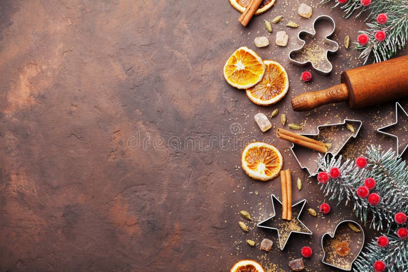 Holiday christmas background for baking cookies with cutters, rolling pin and spices on brown table top view. Copy space for text. stock images Holiday christmas background for baking cookies with cutters, rolling pin and spices on brown table top view. Copy space for text. stock images
