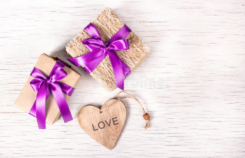 Holiday decorations with gift boxes and wooden heart. St. Valentine`s Day. royalty free stock photography Holiday decorations with gift boxes and wooden heart. St. Valentine`s Day. royalty free stock photography