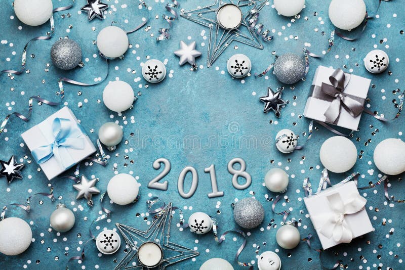 Holiday frame with christmas decoration, gift box, confetti and sequins on vintage blue table top view. Flat lay. New year 2018. Holiday frame with christmas stock image Holiday frame with christmas decoration, gift box, confetti and sequins on vintage blue table top view. Flat lay. New year 2018. Holiday frame with christmas stock image