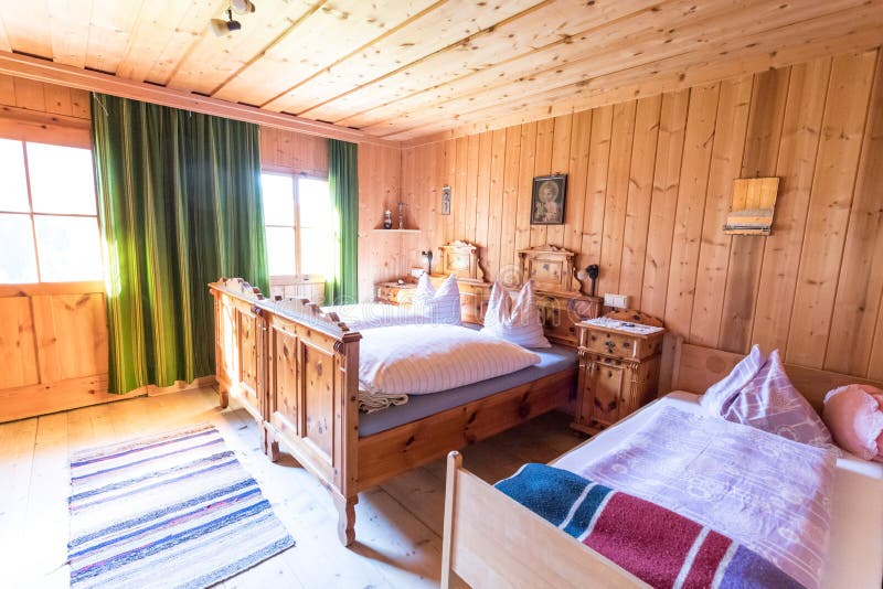 Holiday in the mountains: Rustic old wooden interior of a cabin or hut. Inside of a rustic wooden hut or cabin, Austria interior bed furniture hotel breakfast royalty free stock photography Holiday in the mountains: Rustic old wooden interior of a cabin or hut. Inside of a rustic wooden hut or cabin, Austria interior bed furniture hotel breakfast royalty free stock photography