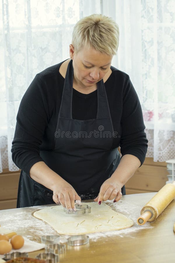 Holiday season baking. Close up woman baking handmade Christmas sugar cookies