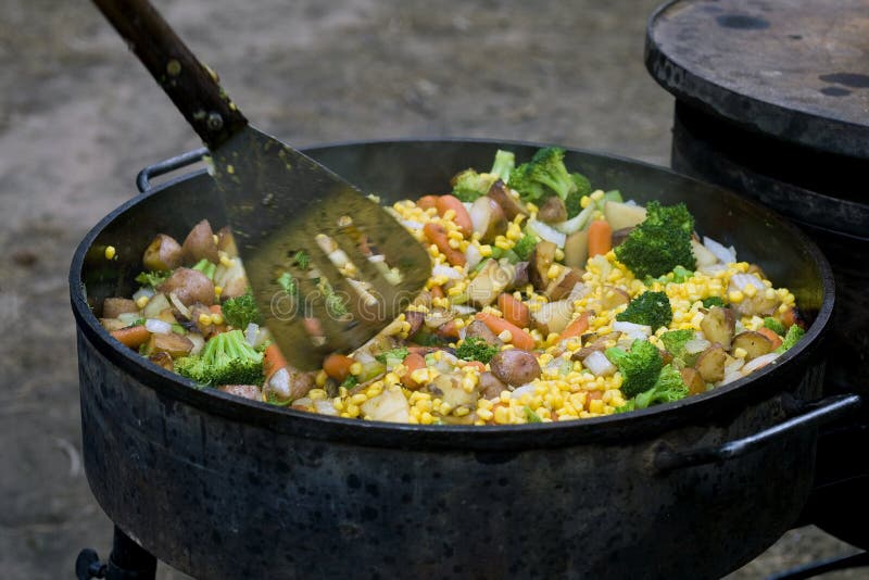 Dutch oven being used to prepare a meal. Dutch oven being used to prepare a meal.