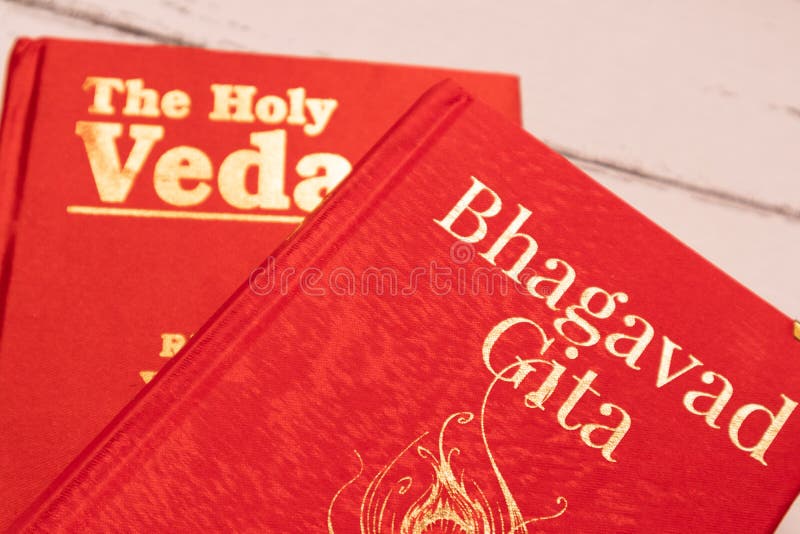 Holy Bhagavad gita and The Holy Veda the oldest scriptures of Hinduism on wooden textured background