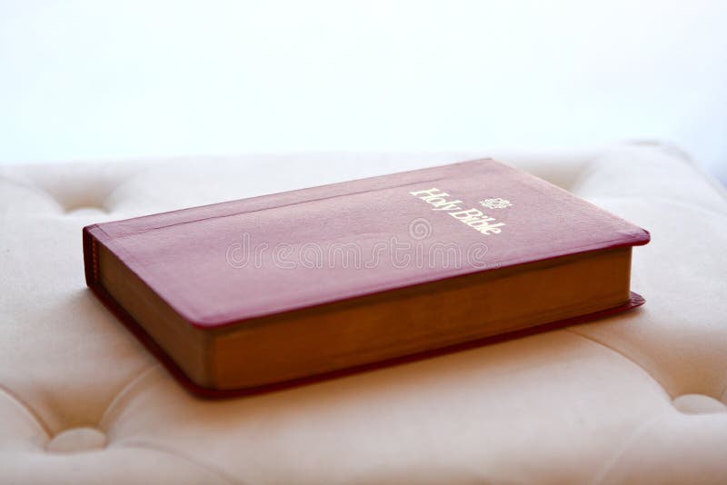 Holy Bible backlit on ottoman cushion