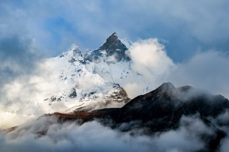 Machapuchare, Fish Tail Mountain rising above the clouds from the Annapurna base camp trail, Nepal royalty free stock photography