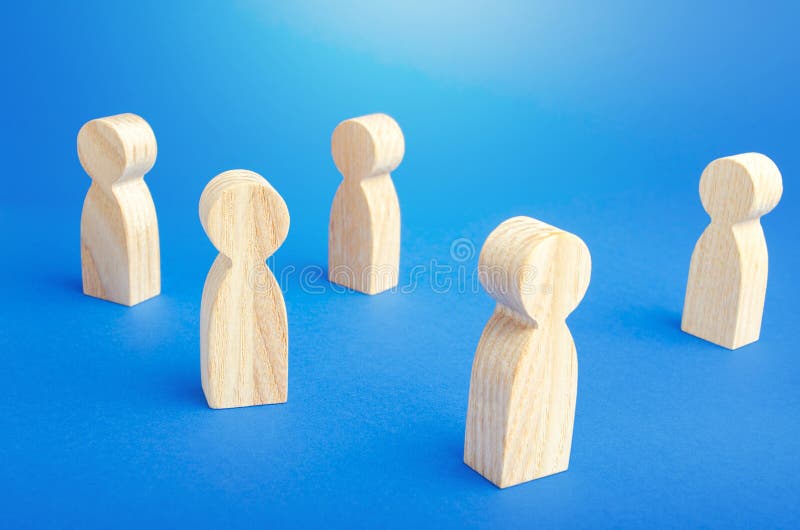 Wooden figurines of people stand on a blue background. Loneliness and disconnection. Safe spacing between persons, new normal. Faceless mass. Communication. Society public. Disunity concept. Wooden figurines of people stand on a blue background. Loneliness and disconnection. Safe spacing between persons, new normal. Faceless mass. Communication. Society public. Disunity concept