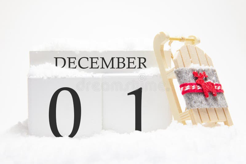 Holzkalender für Dezember, 1. Tag des Wintermonats Die Symbole des Winters sind Schnee und Schlitten Urlaubskonzept