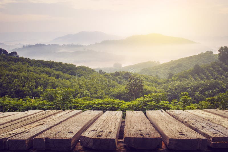 Wooden table and view of mountain with sun light,vintage process picture. Wooden table and view of mountain with sun light,vintage process picture