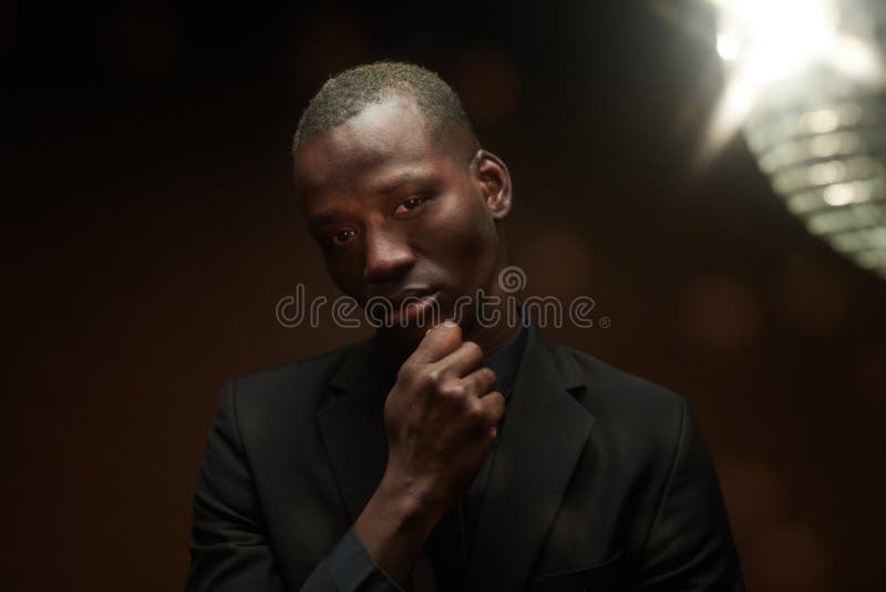 Hombre africano con elegante traje negro imagenes de archivo