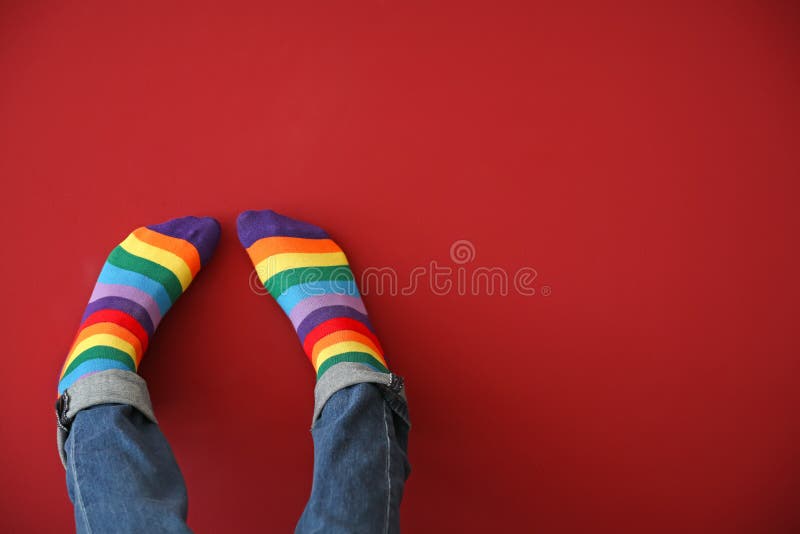 Man with rainbow socks on color background. Man with rainbow socks on color background