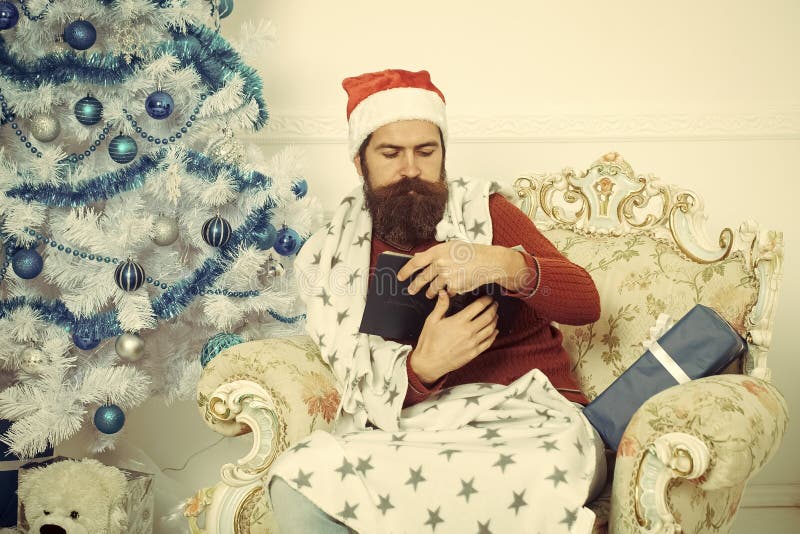 Hombre de la Navidad con la barba en el libro serio de la lectura de la cara fotografía de archivo Hombre de la Navidad con la barba en el libro serio de la lectura de la cara fotografía de archivo