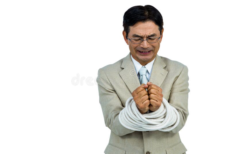 Hombre de negocios asiático atado para arriba en cuerda fotos de archivo libres de regalías Hombre de negocios asiático atado para arriba en cuerda fotos de archivo libres de regalías