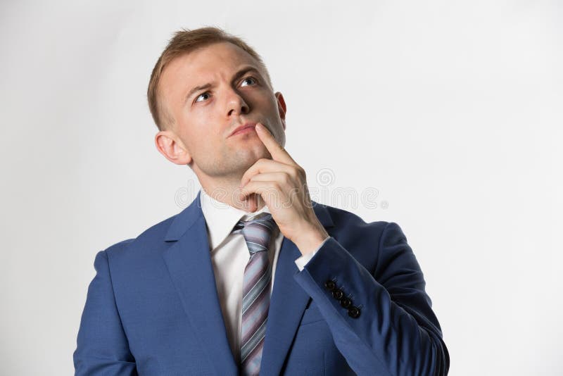 Hombre de negocios con el finger en el pensamiento de la cara imagen de archivo Hombre de negocios con el finger en el pensamiento de la cara imagen de archivo