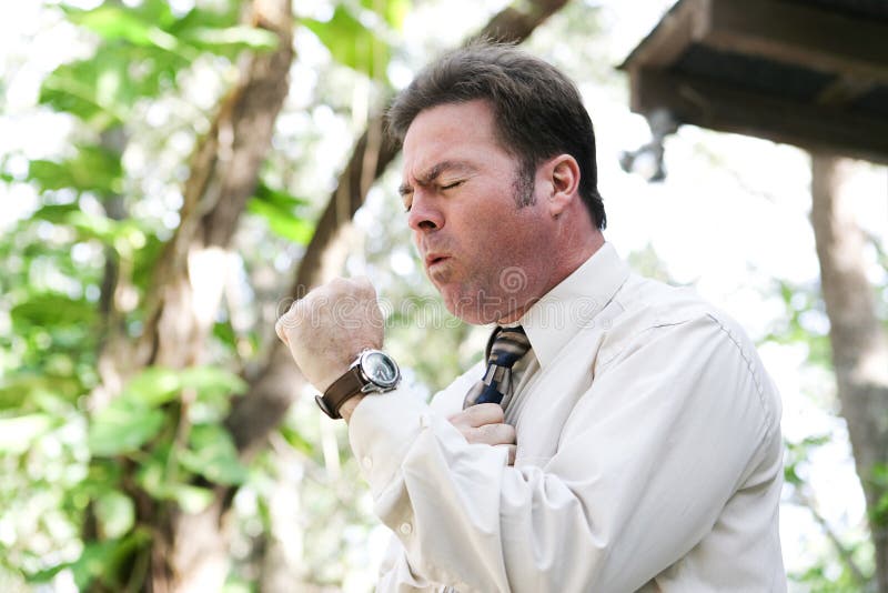Hombre de negocios Coughing con gripe foto de archivo Hombre de negocios Coughing con gripe foto de archivo