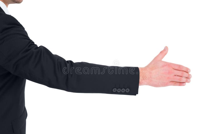 Hombre de negocios en el traje que ofrece su mano fotografía de archivo Hombre de negocios en el traje que ofrece su mano fotografía de archivo