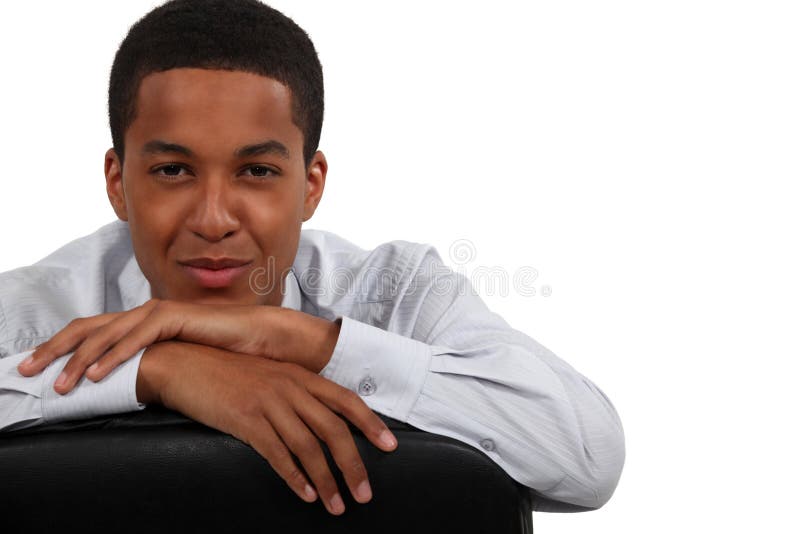 Confident young businessman resting his head on his hands. Confident young businessman resting his head on his hands