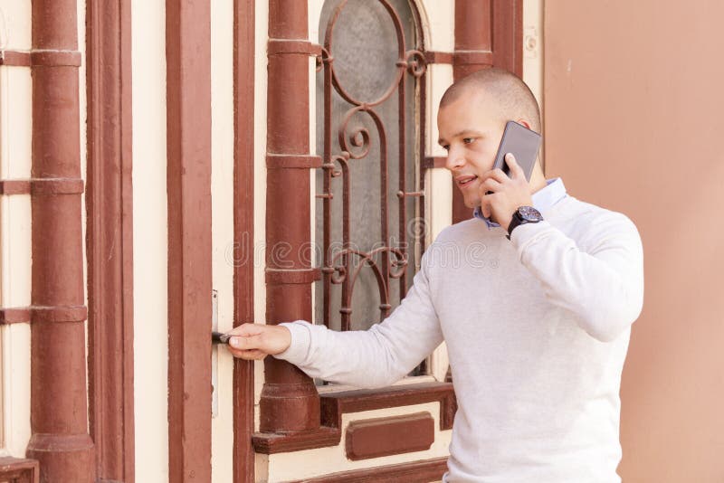 Hombre de negocios joven que habla en el teléfono móvil foto de archivo libre de regalías Hombre de negocios joven que habla en el teléfono móvil foto de archivo libre de regalías