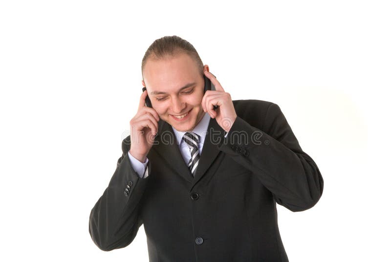 Hombre de negocios sonriente que invita a dos teléfonos fotografía de archivo Hombre de negocios sonriente que invita a dos teléfonos fotografía de archivo
