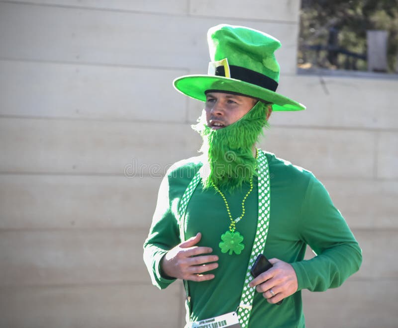 Hombre de Tulsa los E.E.U.U. 3-16-2019 vestido como duende con sacudidas verdes de la barba y del sombrero en la carrera de día d imagen de archivo libre de regalías Hombre de Tulsa los E.E.U.U. 3-16-2019 vestido como duende con sacudidas verdes de la barba y del sombrero en la carrera de día d imagen de archivo libre de regalías
