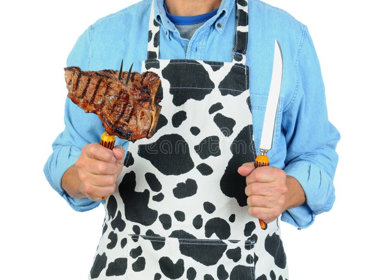 Hombre en delantal con el filete en fork fotografía de archivo Hombre en delantal con el filete en fork fotografía de archivo