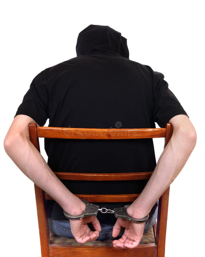 Hombre en esposas en la silla imagen de archivo libre de regalías Hombre en esposas en la silla imagen de archivo libre de regalías