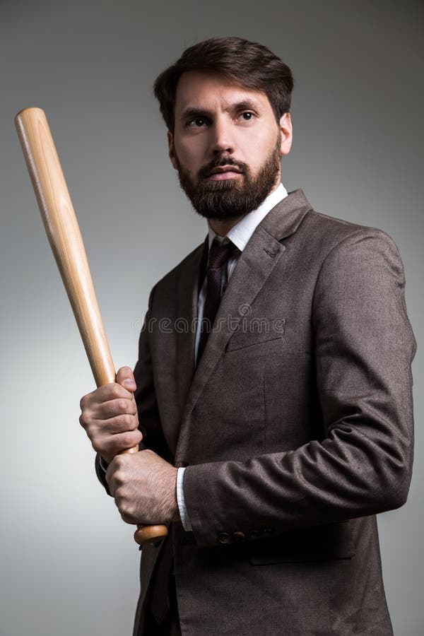 Hombre En Traje Con El Palo Imagen de archivo - Imagen de béisbol, gris ...