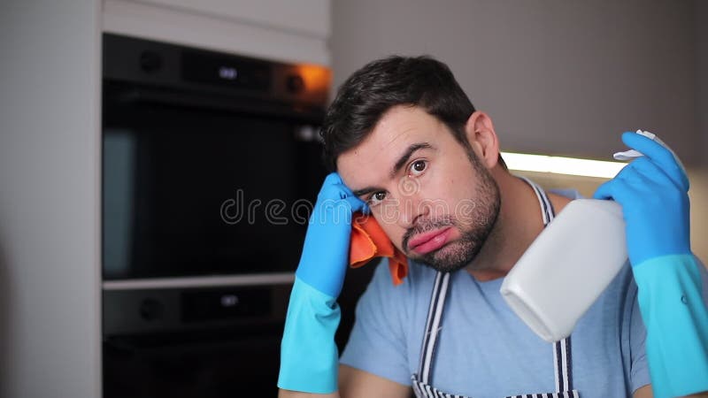 Hombre estresado limpiando su cocina