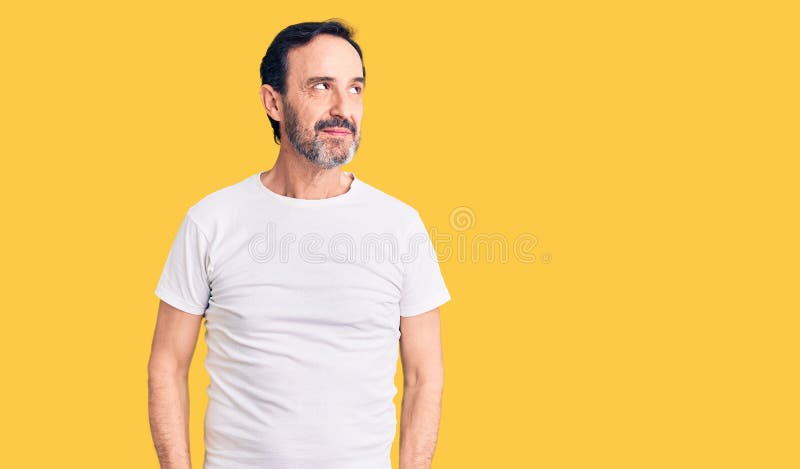 Hombre guapo de mediana edad con camisa casual sonriendo mirando hacia un lado y mirando lejos pensando imagenes de archivo