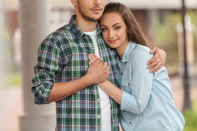 Hombre huging sonriente de la chica joven imagenes de archivo Hombre huging sonriente de la chica joven imagenes de archivo