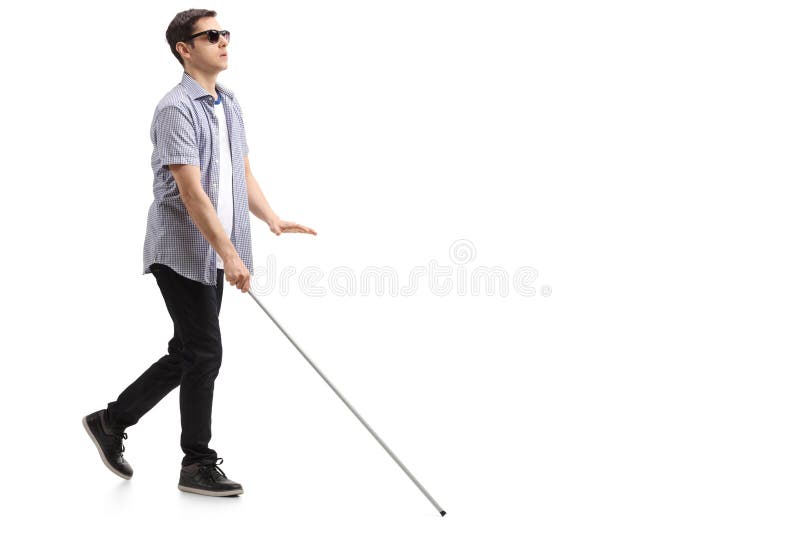 Hombre joven ciego con caminar del bastón fotografía de archivo Hombre joven ciego con caminar del bastón fotografía de archivo