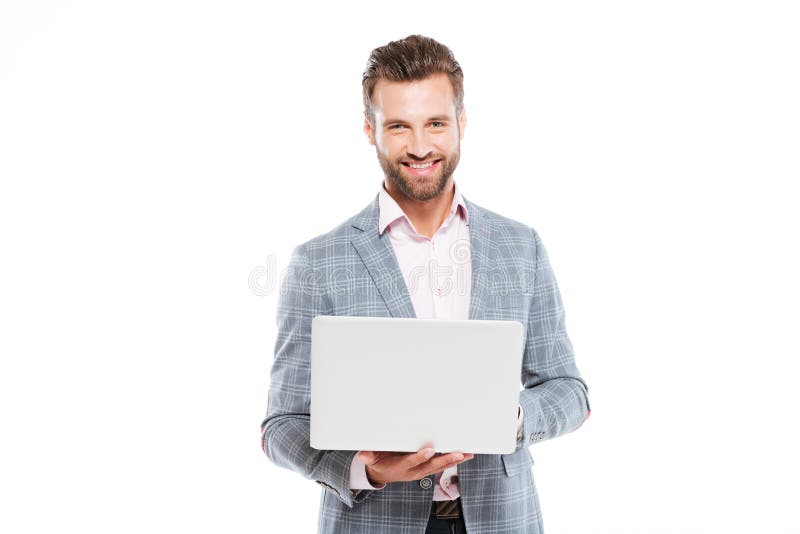Hombre joven feliz que usa el ordenador portátil fotos de archivo libres de regalías Hombre joven feliz que usa el ordenador portátil fotos de archivo libres de regalías