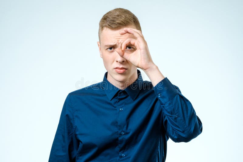 Hombre joven que parece lejos aislado en blanco imagen de archivo Hombre joven que parece lejos aislado en blanco imagen de archivo